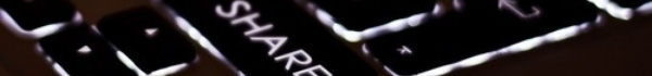 close-up of a keyboard with the word 'share'